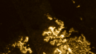Illustration for article titled A Mysterious "Magic Island" Has Appeared On Titan